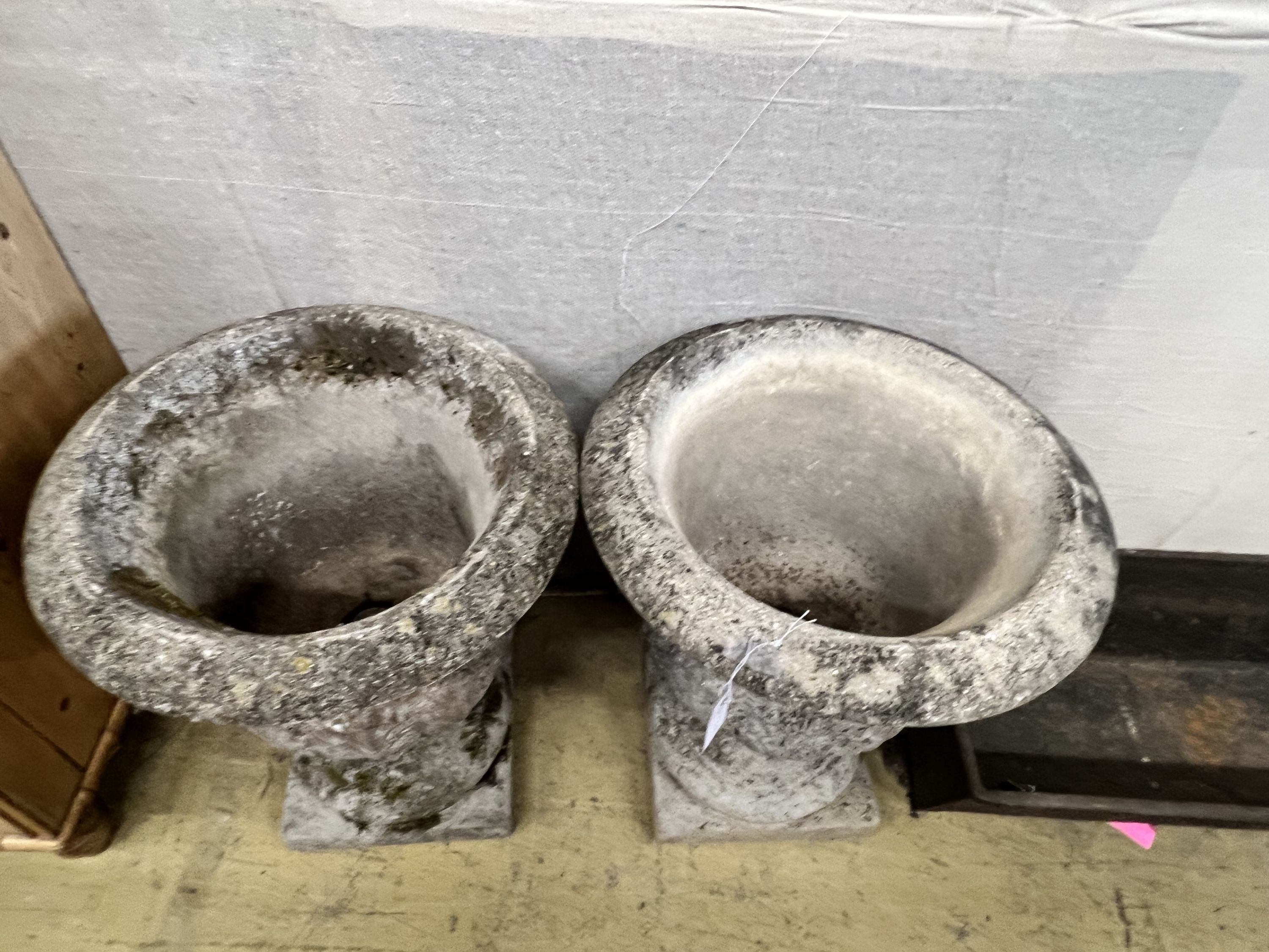 A pair of reconstituted stone acanthus moulded circular campana garden urns, diameter 49cm height 61cm